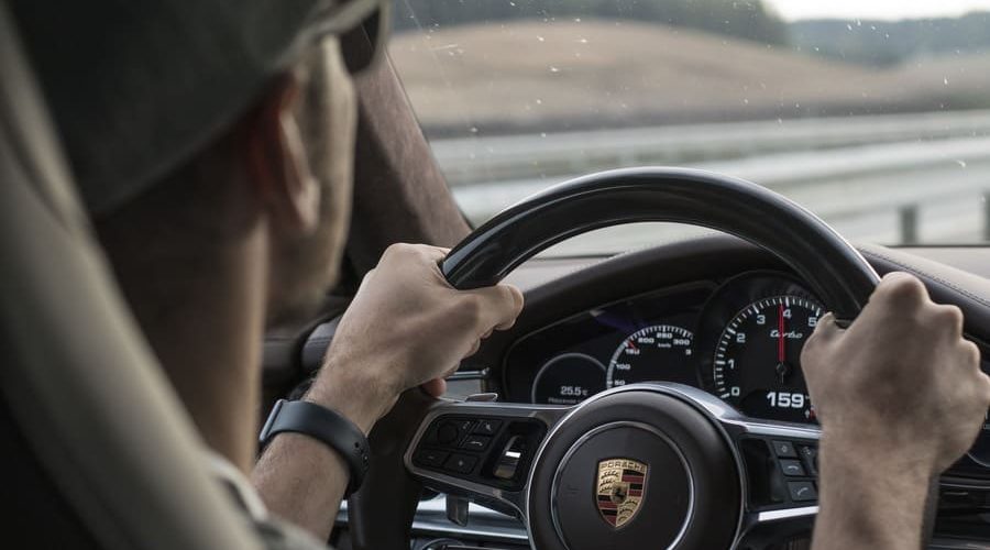 ポルシェを運転する男性